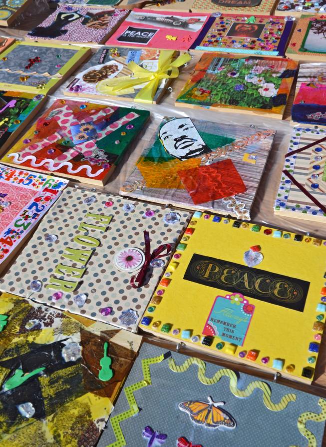 HandsOn Jacksonville and United Way of Northeast Florida came together Saturday Jan. 18, 2014 to do some community events in honor of Martin Luther King Day of Service. One project was a Live the DREAM Global Peace Tiles project in which children, teenagers and adults created tiles, most with themes of hope and peace, that will become part of a wall at the North Point Town Center in Jacksonville, FL where the event was staged. North Point was a project of Northwest Jacksonville CDC. Finished tiles that have been covered with shellac were placed on a table to dry.