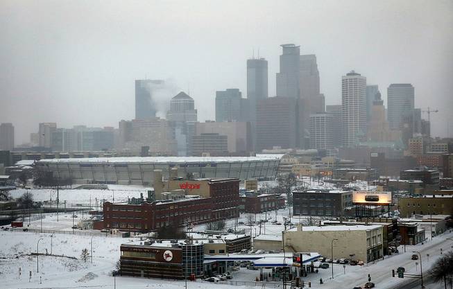 The roof of the Minnesota Vikings' Metrodome is deflated Saturday, Jan. 18, 2014, in downtown Minneapolis. The 10 acres of Teflon-coated fabric were done deflating in 35 minutes. The deflation and the demolition of the Dome beginning next week will make way for construction of a new $1 billion Vikings stadium.