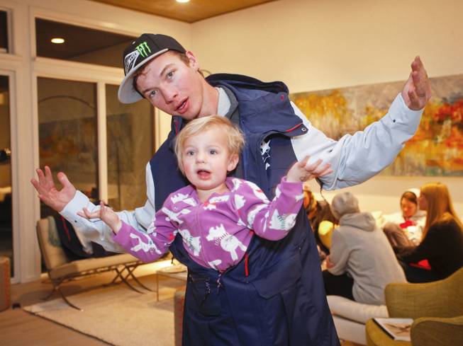 IMAGE DISTRIBUTED FOR THE NORTH FACE - David Wise of Reno, Nevada member of the U.S. Freeskiing Team and his daughter, Nayeli Grace Wise, play around in his new competition uniform from The North Face, while in Aspen, CO this week preparing for the X-Games. Monday, January, 20, 2014 in Aspen, CO. (Photo by Nathan Bilow/Invision for The North Face/AP Images)
