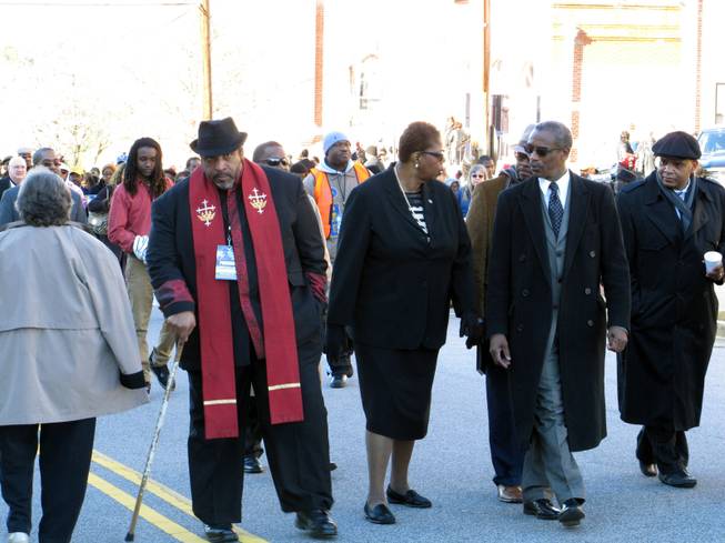 North Carolina NAACP President William Barber, left, interim national NAACP President Lorraine Miller, center, and South Carolina NAACP President Lonnie Randolph, right, march to the South Carolina Statehouse as part of the King Day at the Dome rally on Monday, Jan. 20, 2014, in Columbia, S.C.