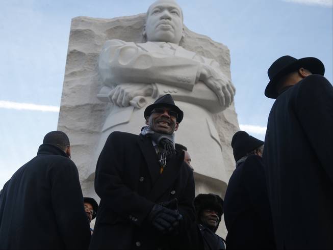 The men's choir from the People's Community Baptist Church in Silver Spring, Md., finishes singing at the Martin Luther King Jr. Memorial in Washington, Monday, Jan. 20, 2014. The nation paused to remember Martin Luther King Jr. Monday with parades, marches and service projects. King was born Jan. 15, 1929, and the federal holiday is the third Monday in January.