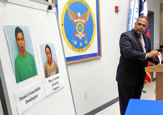 McAllen Police Chief Victor Rodriguez displays photos of Daniel Guardiola Dominiguez, left, and Mary Carmen Garcia, who were arrested Sunday after arriving at the border with 96 fraudulent credit cards that were produced using data stolen during the Target security breach late last year, Monday, Jan. 20, 2014, in McAllen, Texas.