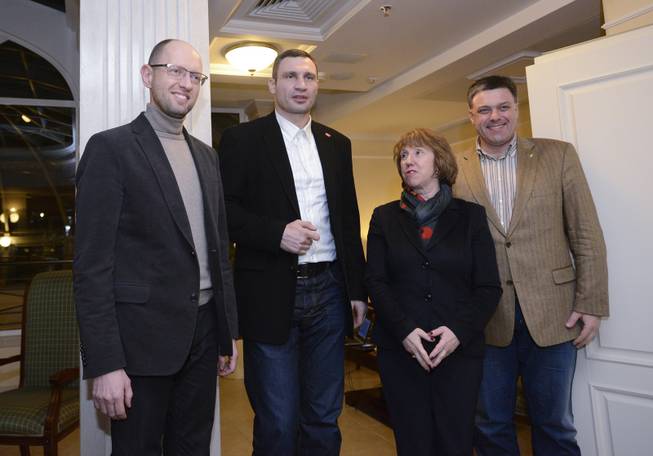 EU foreign policy chief Catherine Ashton, second right, prior her meeting with Ukrainian opposition leaders, Oleh Tyahnybok, right, Arseniy Yatsenyuk, left, and Vitali Klitschko, second left, in Kiev, Ukraine, Tuesday, Dec. 10, 2013. Top Western diplomats headed to Kiev Tuesday to try to defuse a stand-off between President Viktor Yanukovych's government and thousands of demonstrators, following a night in which police in riot gear dismantled protesters' encampments outside government buildings. Demonstrators have occupied the Ukrainian capital for weeks opposing Yanukovych's decision to freeze ties with the European Union and tilt to Russia instead.