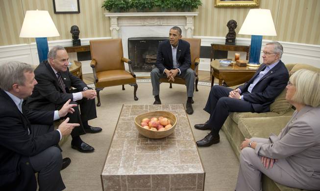 In this Oct. 12, 2013, file photo, from left, Sen. Dick Durbin, D-Ill., Sen. Charles Schumer, D-N.Y., President Barack Obama, Senate Majority Leader Harry Reid of Nevada, Sen. Patty Murray, D-Wash., meet in the Oval Office of the White House in Washington. When Obama delivers his State of the Union address on Jan. 28, 2014, he isn’t just setting out his own agenda. He’s also delivering an opening salvo in the yearlong fight for control of Congress.