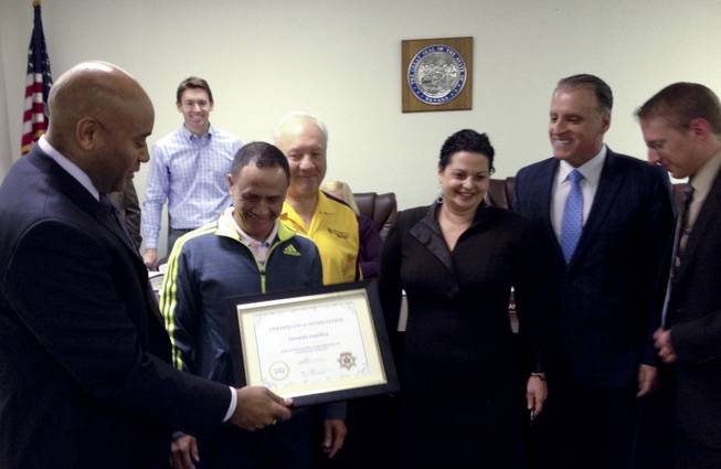 Taxicab Authority Administrator Charles Harvey presents a certificate to Yellow Checker Star cab driver Gerardo Gamboa, who discovered $300,000 in a bag in his cab and returned it to its owner last month. YCS manager Bill Shranko and authority board members Joshua Miller, rear, and Chairman Ileana Drobkin, Dean Collins and Joseph Hardy Jr. were also on hand for the presentation Jan. 28, 2014.