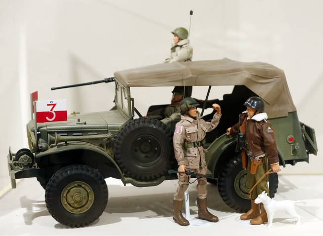 This Jan. 31, 2014, photo shows a Gen. George Patton G.I. Joe action figure, right, and other G.I. Joes in a display at the New York State Military Museum in Saratoga Springs, N.Y. A half-century after the 12-inch doll was introduced at a New York City toy fair, the iconic action figure is being celebrated by collectors with a display at the military museum, while the toy's maker plans other anniversary events to be announced later this month.