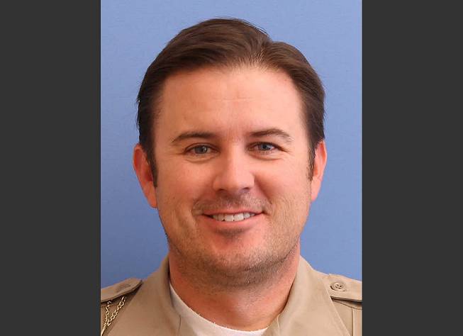 In this undated photo provided by the Utah County Sheriff's Office shows Sgt. Cory Wride, who had stopped to check on a truck that appeared to be disabled on a two-lane highway Thursday, Jan. 30, 2014. He was using his computer to do a background check when he was shot from the truck and killed.