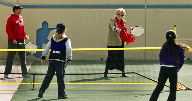 (from left) Director of Tennis Jeff Foley joins Rocci Mendez, 8, Las Vegas Mayor Carolyn G. Goodman and Natalie Cheong, 9, in a few volleys at the Darling Tennis Center on Tuesday, Feb. 04, 2014. The mayor was on hand to announce the arrival of the Las Vegas Neon of the Mylan World Team Tennis here.