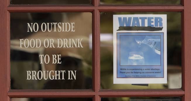 In this photo taken Tuesday, Feb. 4, 2014, diners at the Country Skillet restaurant, in Willits,Calif. are reminded of the water shortage facing the community. In the midst of an historic drought and area reservoirs holding less than a 100-day supply of water, Willits city leaders have banned lawn watering, car washing and have asked restaurants to serve water only upon request.