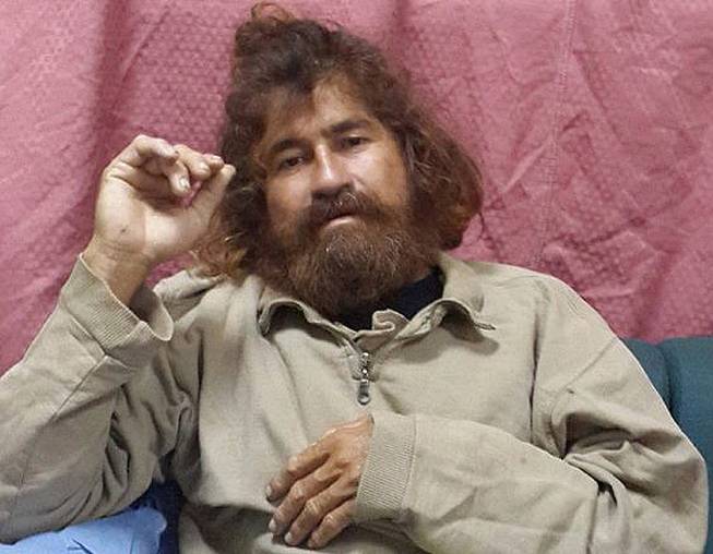 In this Monday, Feb. 3, 2014, photo provided by the Marshall Islands Foreign Affairs Department, a man identifying himself as 37-year-old Jose Salvador Alvarenga sits on a couch in Majuro in the Marshall Islands, after he was rescued from being washed ashore on the tiny atoll of Ebon in the Pacific Ocean.