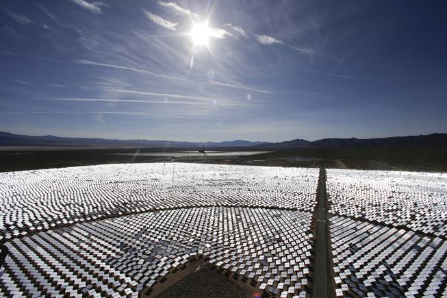Some of the 300,000 computer-controlled mirrors, each about 7 feet high and 10 feet wide, reflect sunlight to boilers that sit on 459-foot towers. The sun's power is used to heat water in the boilers' tubes and make steam, which in turn drives turbines to create electricity Tuesday, Feb. 11, 2014, in Primm.