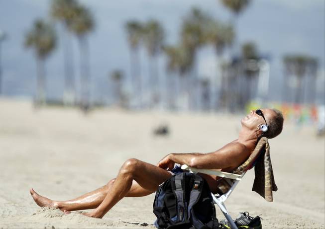 Venice Beach resident David Lomax enjoys the warm weather in the Venice Beach area of Los Angeles, Friday, Feb. 14, 2014. With much of the Northeast gripped by snow and ice storms, the Southwest is riding a heat wave that is setting record high temperatures and sent people to beaches and golf courses in droves Friday.