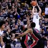 Utah State's Preston Medlin lines up to shoot over UNLV's Kevin Olekaibe and Christian Wood (5) during an NCAA college basketball game Saturday, Feb. 15, 2014, in Logan, Utah. Utah State's Preston Medlin lines up to shoot over UNLV's Kevin Olekaibe and Christian Wood (5) during an NCAA college basketball game Saturday, Feb. 15, 2014, in Logan, Utah.