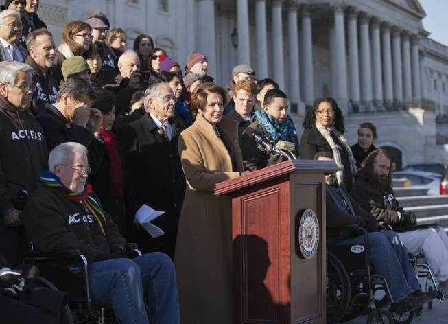 In this Dec. 12, 2013, file photo House Minority Leader Nancy Pelosi, D-Calif., at the podium, is joined by Congressional Hispanic Caucus Chairman Rep. Ruben Hinojosa, D-Texas, to her left, as she calls for action on immigration reform on Capitol Hill in Washington with other lawmakers and activists. Democrats are planning to rely on an infrequently used and rarely successful tactic to shine an election-year spotlight on Republican opposition to raising the minimum wage and overhauling immigration laws: it’s known as a "discharge petition.” It requires the minority party to persuade some two dozen Republicans to defy their leadership.