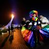 Vladimir Luxuria, center, a former Communist lawmaker in the Italian parliament and prominent crusader for transgender rights, is led away by friends to attend a women's ice hockey match after posing for photos on the Olympic Plaza at the 2014 Winter Olympics, Monday, Feb. 17, 2014, in Sochi, Russia. Luxuria was soon after detained by police upon entering the Shayba Arena. Vladimir Luxuria, center, a former Communist lawmaker in the Italian parliament and prominent crusader for transgender rights, is led away by friends to attend a women's ice hockey match after posing for photos on the Olympic Plaza at the 2014 Winter Olympics, Monday, Feb. 17, 2014, in Sochi, Russia. Luxuria was soon after detained by police upon entering the Shayba Arena.