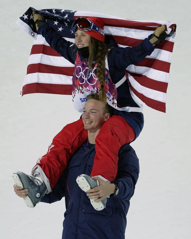Maddie Bowman of the United States celebrates her gold medal in the women's ski halfpipe final, on the shoulders of David Wise, the men's half pipe gold medal winner, at the Rosa Khutor Extreme Park, at the 2014 Winter Olympics, Thursday, Feb. 20, 2014, in Krasnaya Polyana, Russia.