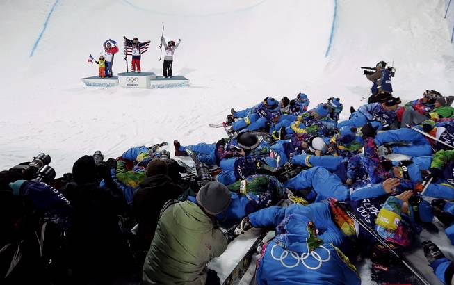 Maddie Bowman of the United States, center, celebrates after winning the gold medal in the women's ski halfpipe final, with silver medalist Marie Martinod of France, left, Martinod's daughter Meli Rose, 4, and bronze medalist Japan's Ayana Onozuka, right, at the Rosa Khutor Extreme Park, at the 2014 Winter Olympics, Thursday, Feb. 20, 2014, in Krasnaya Polyana, Russia.