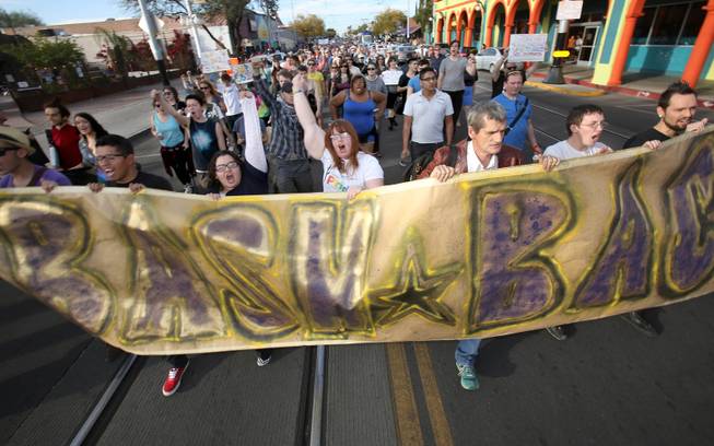 More than 200 marchers walk from the Wingspan office along North Fourth Avenue to the Governor's office at 400 W Congress St. in Tucson, Ariz., Friday, Feb. 21, 2014, to rally against the State Legislature's passage of the "religious freedom bill." Supporters of the rally, including elected officials and clergy, are urging Gov. Jan Brewer to veto the bill. (The sign at front of the protest reads, "Bash back.") Local business leaders are also not in favor of the bill which is the first of its kind in the country citing it is bad for business development.