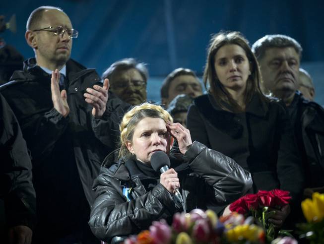 Former Ukrainian prime minister Yulia Tymoshenko, center, addresses the crowd in central Kiev, Ukraine, Saturday, Feb. 22, 2014. Hours after being released from prison, the former Ukrainian prime minister and opposition icon praised the demonstrators killed in violence this week as heroes.