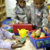 Photo: Oumou Balde, 4, left, plays with her teacher Jacqu Photo: Oumou Balde, 4, left, plays with her teacher Jacqu
