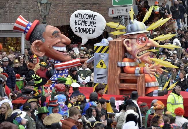 A carnival float depicting US president Barack Obama, left, putting whistleblower Edward Snowden on an electric chair during the traditional carnival parade in Duesseldorf, western Germany, on Monday, March 3, 2014. The foolish street spectacles in the carnival centers of Duesseldorf, Mainz and Cologne, watched by hundreds of thousands of people, are the highlights in Germany's carnival season on Rose Monday.