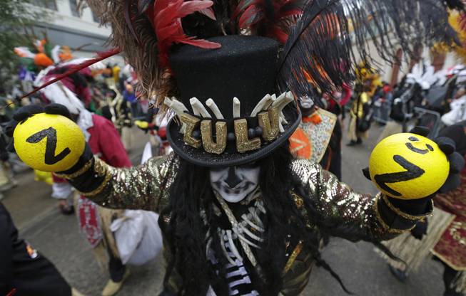 Members of the Krewe of Zulu march during Mardi Gras day in New Orleans, Tuesday, March 4, 2014. Despite rain and cold in Tuesday's forecast, revelers are gathering along parade routes as the Carnival season in New Orleans heads to a crest with the unabashed celebration of Mardi Gras. The Zulu parade began on schedule, led by a New Orleans police vanguard on horseback that included Mayor Mitch Landrieu.