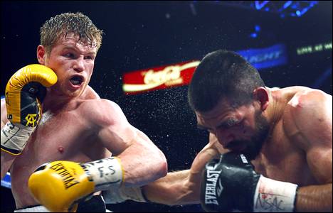 Canelo Alvarez, left, connects on Alfredo Angulo, both of Mexico, during their super welterweight fight at the MGM Grand Garden Arena Saturday, March 8, 2014.