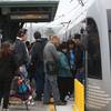 Photo: Pedestrians board a train at Union Station Friday Photo: Pedestrians board a train at Union Station Friday