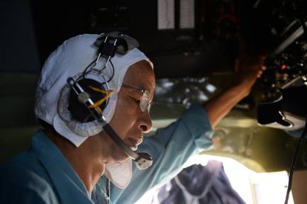 A Vietnamese air force pilot touches the controls of a transport plane Sunday, March 9, 2014, during the search and rescue operations for the Malaysian airliner vanished Saturday on a flight from Kuala Lumpur to Beijing.