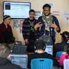 In this Monday, Feb. 10, 2014, photo, members of The Flobots and Youth on Record founders James Laurie, center, and Stephen Brackett, right, work with music students at Youth on Record headquarters in Denver. In this Monday, Feb. 10, 2014, photo, members of The Flobots and Youth on Record founders James Laurie, center, and Stephen Brackett, right, work with music students at Youth on Record headquarters in Denver.