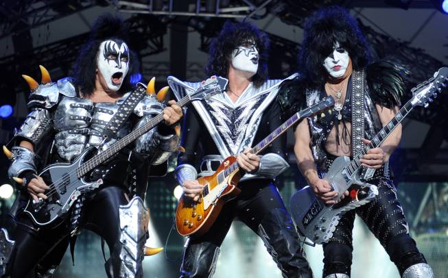 In this Thursday, June 13, 2013, file photo, from left, bassist Gene Simmons, guitarist Tommy Thayer and singer Paul Stanley of the band Kiss perform on stage in Berlin, Germany. Kiss announced Sunday, Feb. 23, 2014 that the band will not perform when they are inducted into the Rock and Roll Hall of Fame in Cleveland in April.