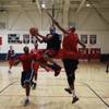 Findlay Prep guard Derryck Thornton Jr. drives to the basket while being defended by coaches Rodney Haddix, left, and Jerome Williams during practice Tuesday, March 18, 2014. Findlay Prep guard Derryck Thornton Jr. drives to the basket while being defended by coaches Rodney Haddix, left, and Jerome Williams during practice Tuesday, March 18, 2014.