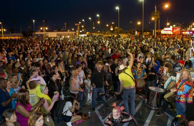 Crowd members dance to drummers and singing at Life Cube, an interactive community art installation, during burn celebrations in downtown Las Vegas, Friday March 21, 2014. The Life Cube, a creation of artist Scott Cohen, was a 24-by-24-foot plywood cube, painted by artists and filled with notes from thousands of people.