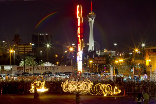 Fire twirlers entertain the crowd as Life Cube, an interactive community art installation, is soon to be in flames in downtown Las Vegas, Friday March 21, 2014. The Life Cube, a creation of artist Scott Cohen, was a 24-by-24-foot plywood cube, painted by artists and filled with notes from thousands of people.