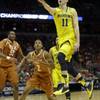 Michigan guard Nik Stauskas drives to the basket during the first half of a third-round game against Texas in the NCAA college basketball tournament Saturday, March 22, 2014, in Milwaukee. Michigan guard Nik Stauskas drives to the basket during the first half of a third-round game against Texas in the NCAA college basketball tournament Saturday, March 22, 2014, in Milwaukee.