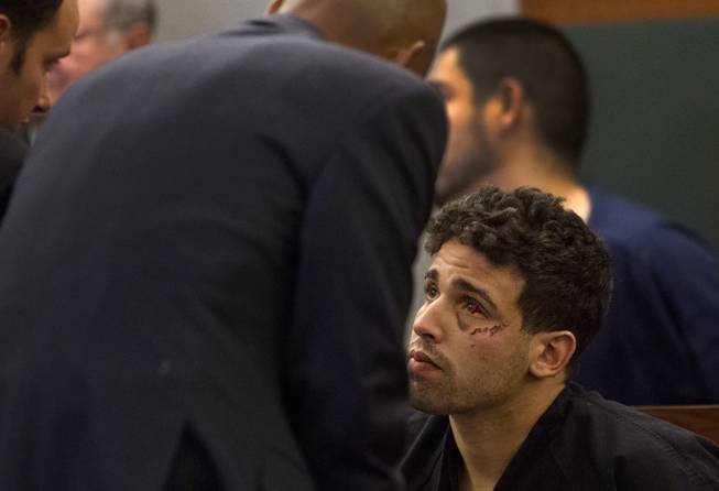 Joey Kadmiri, who is accused of trying to steal costumes from Thunder Down Under and then pulling a gun on the male revue's performers, consults with his lawyer Carl Arnold on Monday, March 24, 2014. Kadmiri was waiting to be arraigned in Las Vegas Township Justice Court at the Clark County Regional Justice Center.