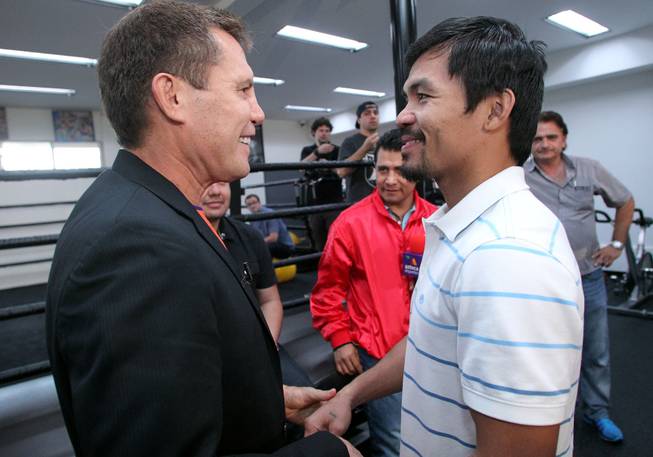 Manny Pacquiao, right, talks with legendary champions Julio Cesar Chavez Sr., left, and Marco Antonio Barrera, center, at the Wild Card Boxing Club in Hollywood, Calif. during training Monday, March 24, 2014, for his eagerly-anticipated rematch against undefeated WBO World Welterweight champion Timothy Bradley.