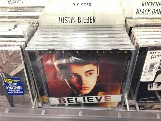 A CD that appears to be Justin Bieber's "Believe" sits on the rack at the Best Buy in Culver City, Calif., Tuesday April 1, 2014. Paz, a 25-year-old electronic musician and artist, says he's planted 5,000 copies of an album that appears to be Bieber's "Believe" but that actually contains a copy of his own CD in retailers such as Best Buy, Walmart and Target on April Fool's Day. This album turned out to be a copy of Paz's CD.