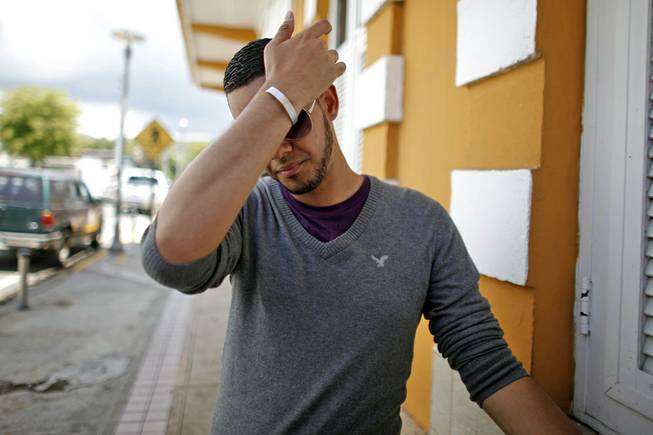 Lopez family spokeman, Glidden Lopez, gestures during an interview with the press in Guayanilla, Puerto Rico, Thursday, April 3, 2014. Soldier, Spc. Ivan Lopez, opened fire Wednesday on fellow service members at the Fort Hood military base, killing three people and wounding 16 before committing suicide.