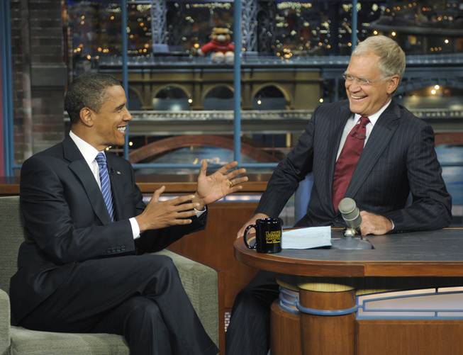 In this photo released by CBS, Democratic presidential candidate Sen. Barack Obama, D-Ill., left, talks with host David Letterman on the set of "The Late Show With David Letterman," Wednesday, Sept. 10, 2008. It was Obama's fifth visit to the show. When John McCain decided to cast Barack Obama as feckless upstart, an empty suit, he reached for the dirtiest word he could use: "celebrity."