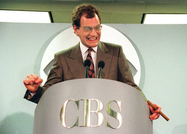 This Jan. 15, 1993 file photo shows talk-show host David Letterman announces his new contract with CBS television for his new show "The Late Show with David Letterman," in New York. Letterman announced his retirement during a taping on Thursday, April 3, 2014. Although no specific date was announced he told the audience that he will leave his desk sometime in 2015.