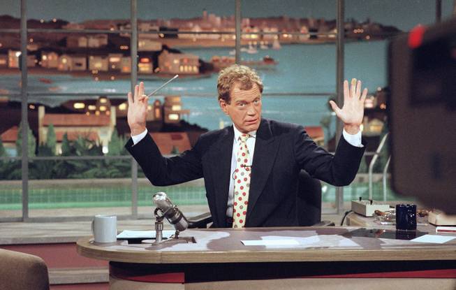This May 9, 1994 file photo released by CBS shows David Letterman gesturing during a week-long taping of the "Late Show with David Letterman," in Los Angeles. Letterman announced his retirement during a taping on Thursday, April 3, 2014. Although no specific date was announced he told the audience that he will leave his desk sometime in 2015.