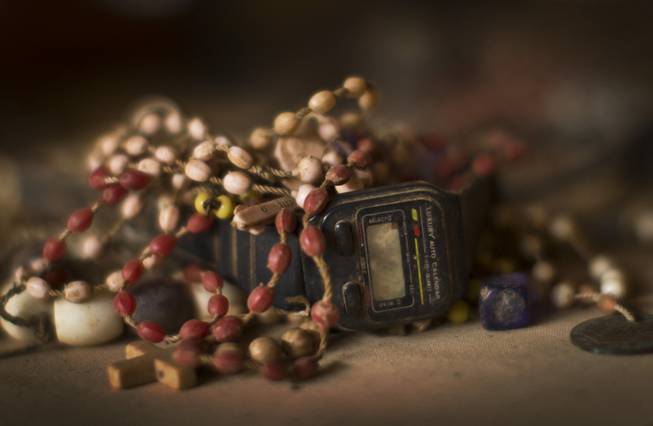Bracelets, a watch, and other belongings of some of those who were slaughtered as they sought refuge inside the church, are laid out on the altar as a memorial to the thousands who were killed during the 1994 genocide in and around the Catholic church in Nyamata, Rwanda Friday, April 4, 2014.