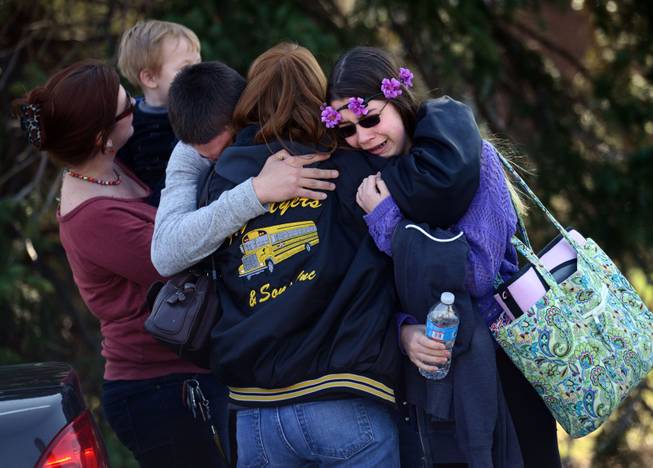 Parents and students embrace along School Road near Franklin Regional High School after more than a dozen students were stabbed by a knife wielding suspect at the school on Wednesday, April 9, 2014, in Murrysville, Pa., near Pittsburgh. The suspect, a male student, was taken into custody and is being questioned.