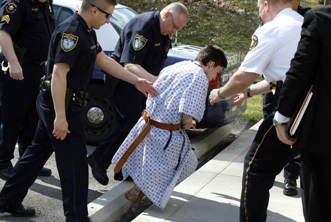 Alex Hribal, center, the suspect in the stabbings at the Franklin Regional High School near Pittsburgh, is taken from a district magistrate after he was arraigned on charges in the attack on Wednesday, April 9, 2014 in Export, Pa. Authorities say Hribal has been charged after allegedly stabbing and slashing at least 19 people, mostly students, in the crowded halls of his suburban Pittsburgh high school Wednesday.