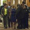Photo: A woman, center, is led away by a security team af Photo: A woman, center, is led away by a security team af