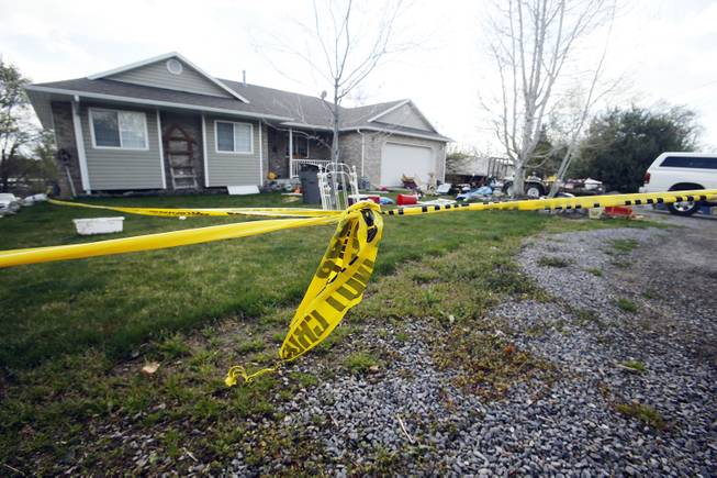 Pleasant Grove Police investigate the scene where seven infant bodies were discovered and packaged in separate containers at a home in Pleasant Grove, Utah, Sunday, April 13, 2014. According to the Pleasant Grove Police Department, seven dead infants were found in the former home of Megan Huntsman, 39. Huntsman was booked into jail on six counts of murder. (AP Photo/Deseret News, Jeffrey D. Allred) MANDATORY CREDIT