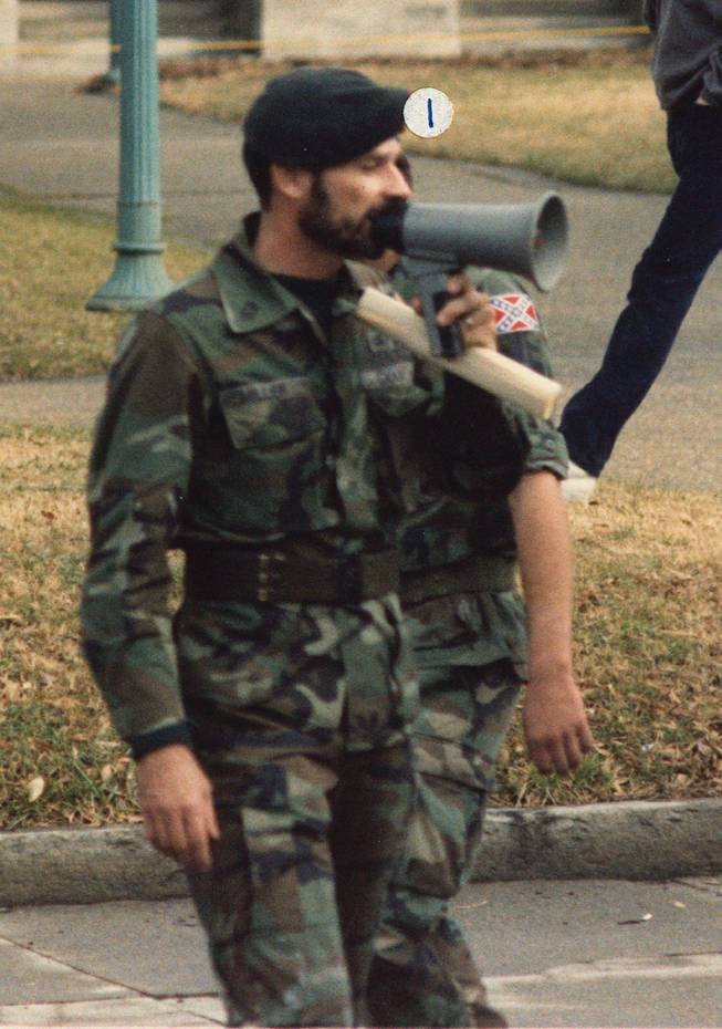 In this Jan. 18, 1986 photo released by Southern Poverty Law Center shows Frazier Glenn Cross, also known as Frazier Glenn Miller, at a Martin Luther King holiday protest in Raleigh, N.C. Cross, 73, accused of killing three people in attacks at a Jewish community center and Jewish retirement complex near Kansas City on Sunday, April 13, 2014, is a known white supremacist and former Ku Klux Klan leader who was once the subject of a nationwide manhunt. He was booked into Johnson County jail on a preliminary charge of first-degree murder. The identifier label above Cross' head was placed by the source.