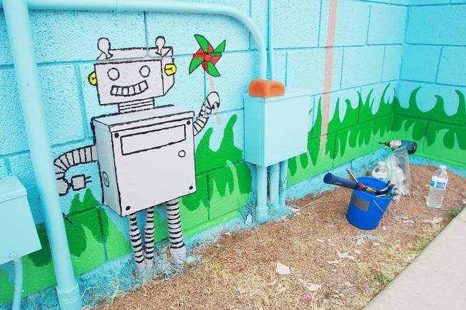 A mural that incorporated an electrical box is seen as volunteers work on building a KaBoom playground for Child Haven Tuesday, April 15, 2014. Clark County Department of Family Services and Chicanos Por La Causa teamed up with volunteers from DirectTV and local businesses to rebuild the playground that was closed in 2012.
