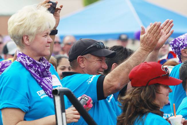 Volunteers cheer as the ribbon is cut on a KaBoom playground they built for Child Haven Tuesday, April 15, 2014. Clark County Department of Family Services and Chicanos Por La Causa teamed up with volunteers from DirectTV and local businesses to rebuild the playground that was closed in 2012.